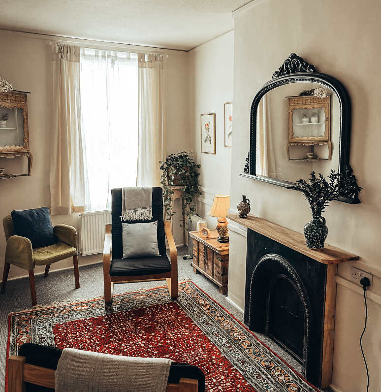 A consulting room with a fireplace, armchairs and soft natural light, at The Practice Rooms in London